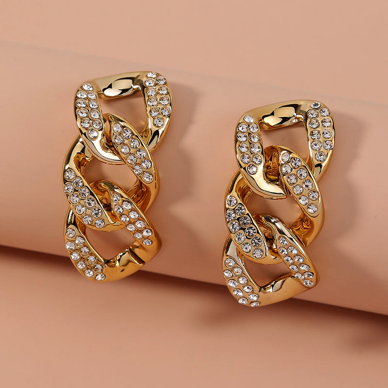 Exaggerated studs with short chains and diamond studs