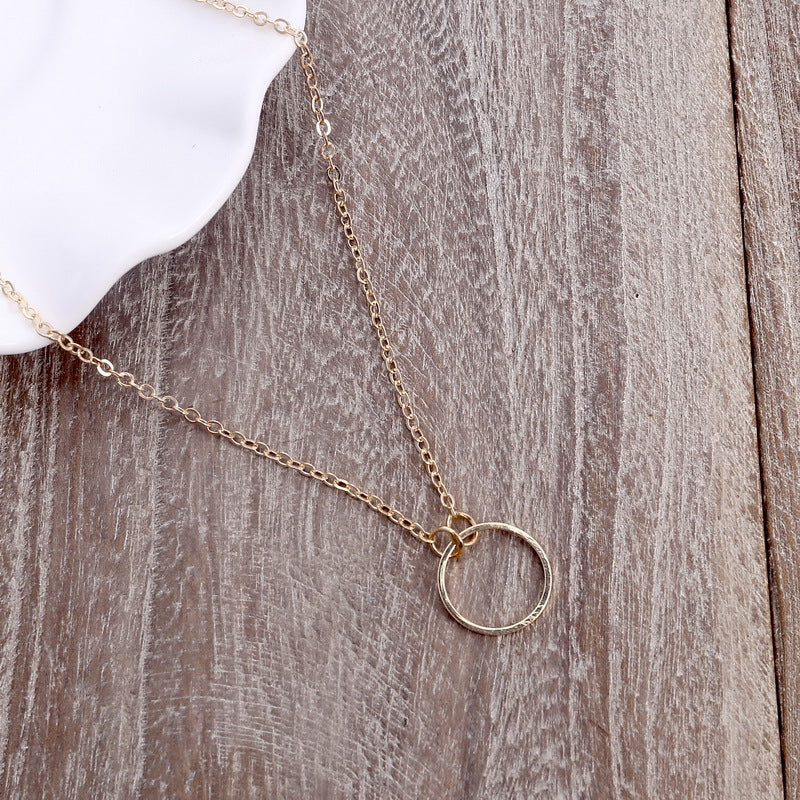 Delicate brass ring necklace